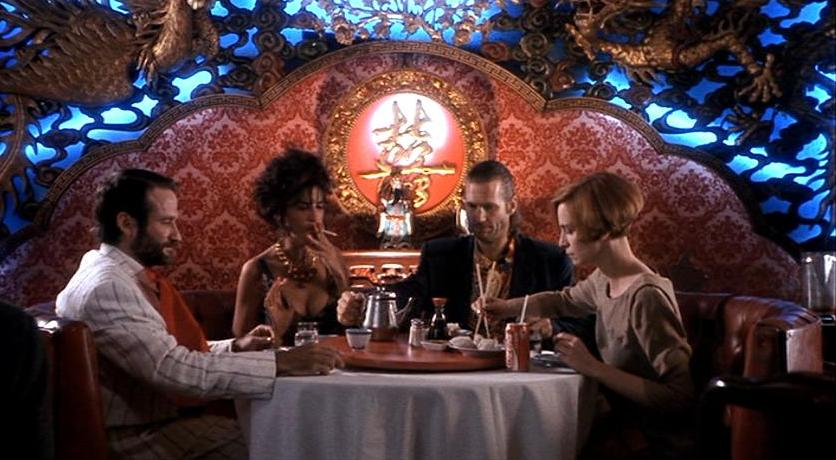 Two couples at a table in a very decorated Chinese restaurant.